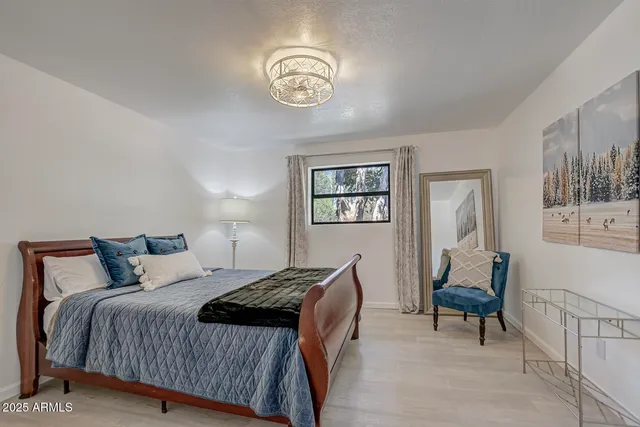 a bedroom with a bed and a chandelier