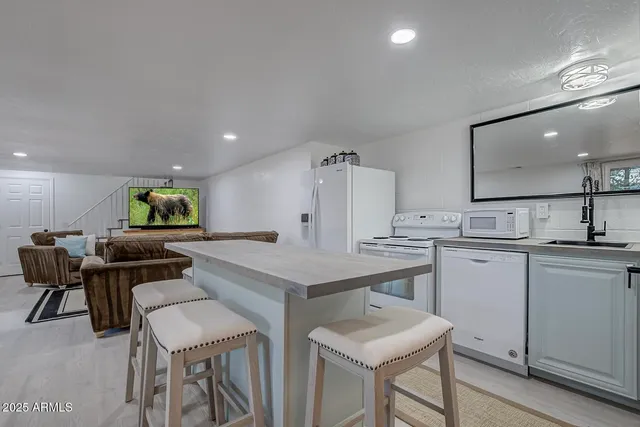 a kitchen with a table and chairs in it