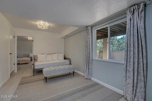 a spacious bedroom with a bed and a window