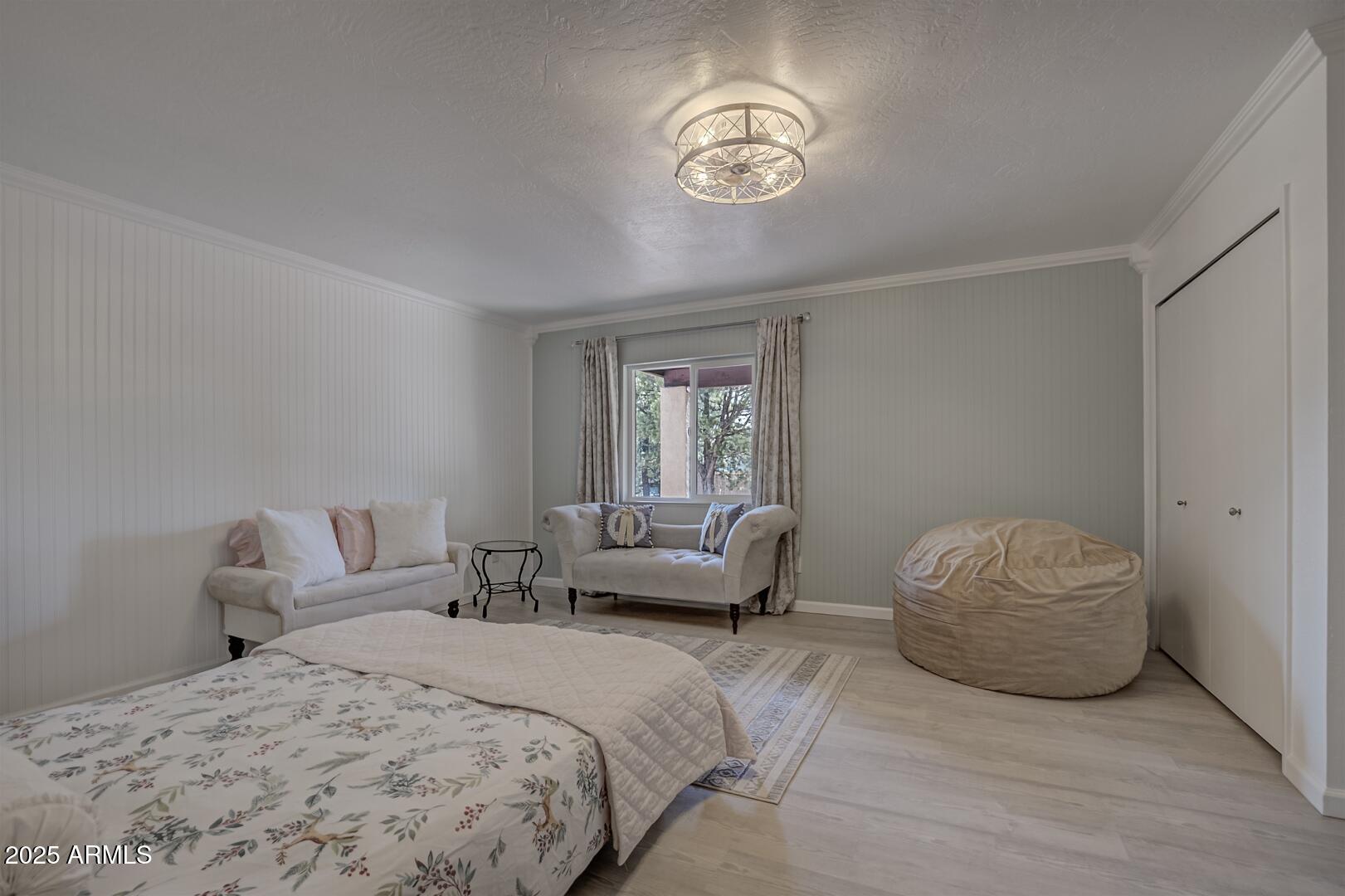 1303 North Sunshine Lane Payson, AZ 85541 - Photo 27 of 29 a bedroom with a bed and a chandelier