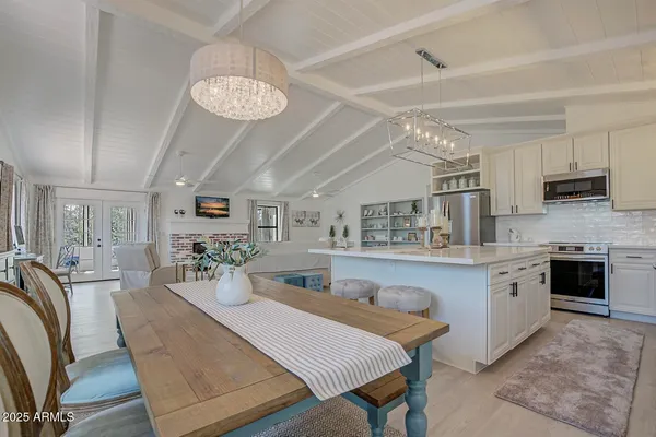 a large kitchen with a table and chairs
