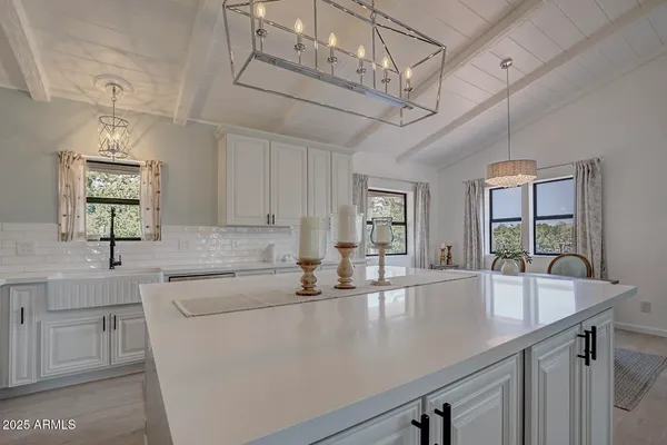 a kitchen with stainless steel appliances granite countertop a sink a counter space and cabinets
