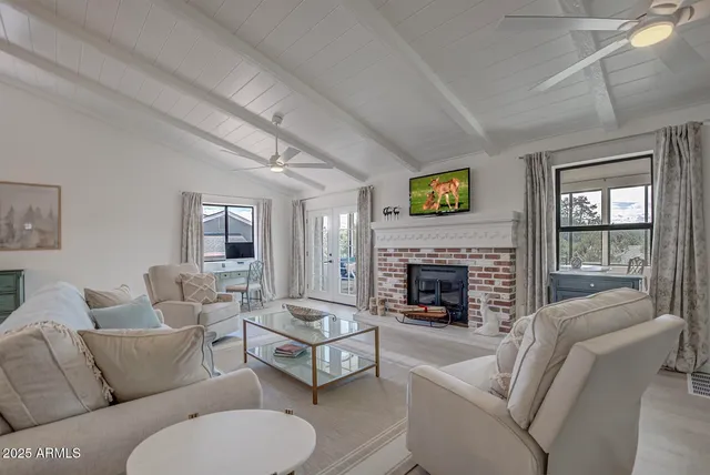 a living room with furniture fireplace and window