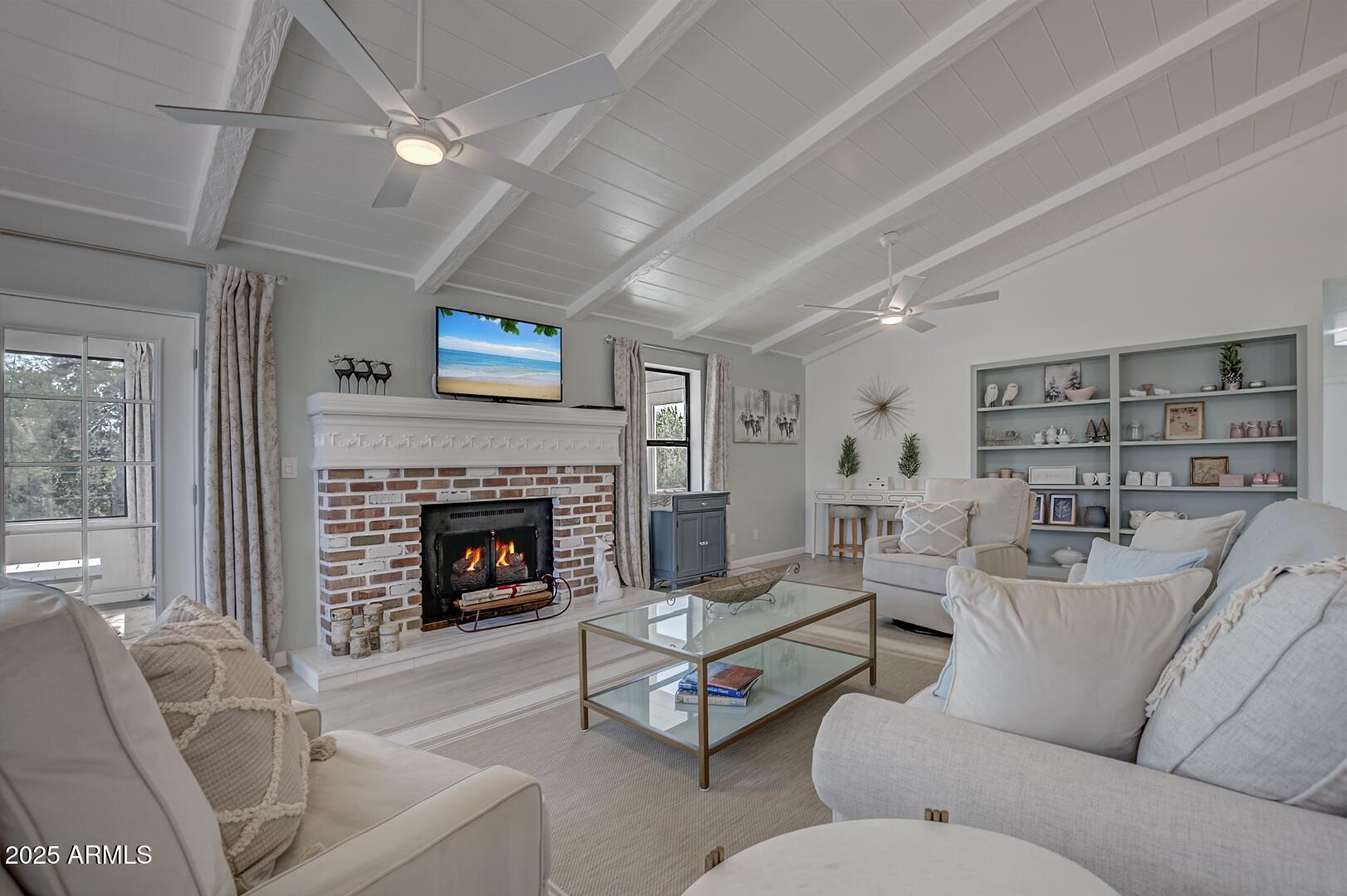 1303 North Sunshine Lane Payson, AZ 85541 - Photo 8 of 29 a living room with furniture a fireplace and a flat screen tv
