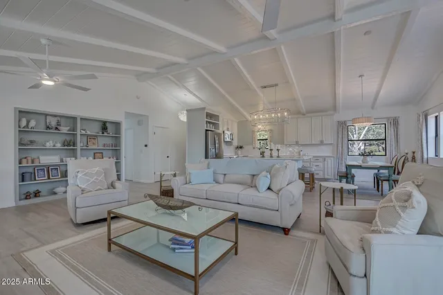 a living room with furniture and view of kitchen