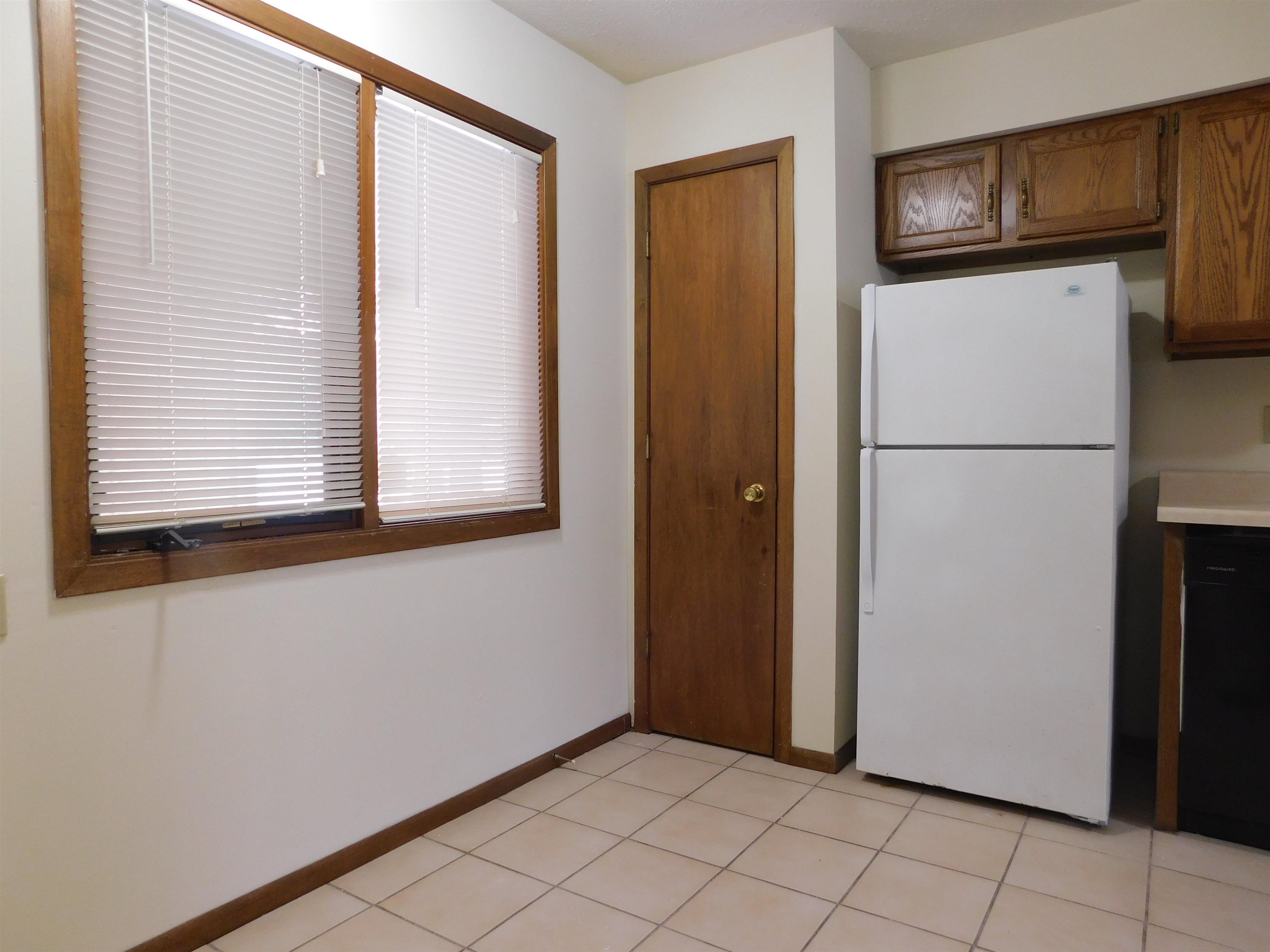 7329 Travertine Trail Rockford, IL 61107 - Photo 7 of 17 a view of a refrigerator in kitchen and a window