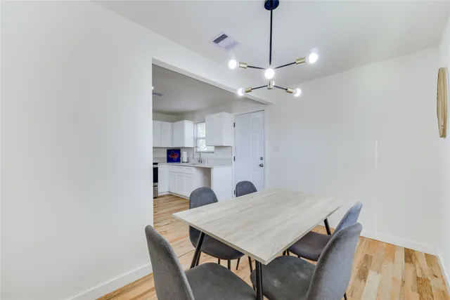 a kitchen with a table and chairs