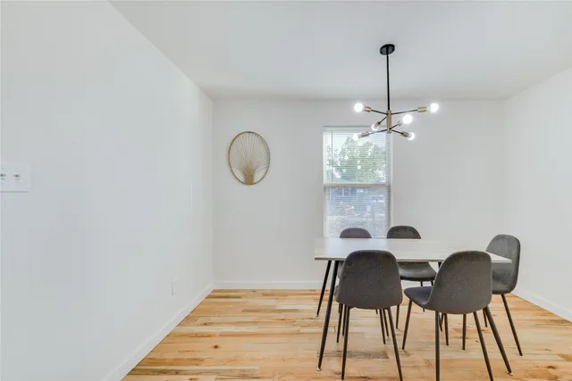 a view of a dining room with furniture wooden floor and chandelier