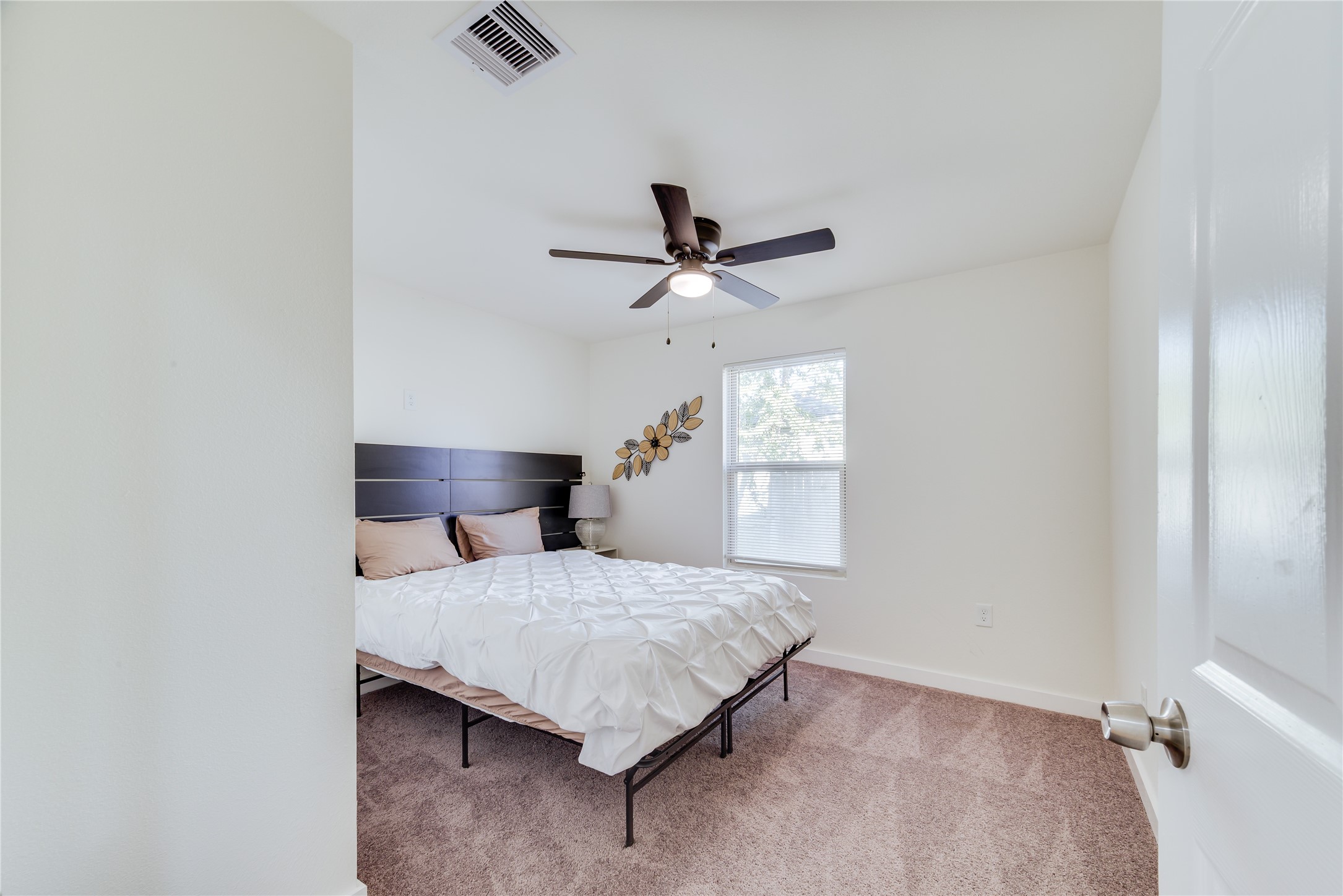 6603 Victoria Street Houston, TX 77020 - Photo 14 of 34 a bedroom with a bed and a ceiling fan