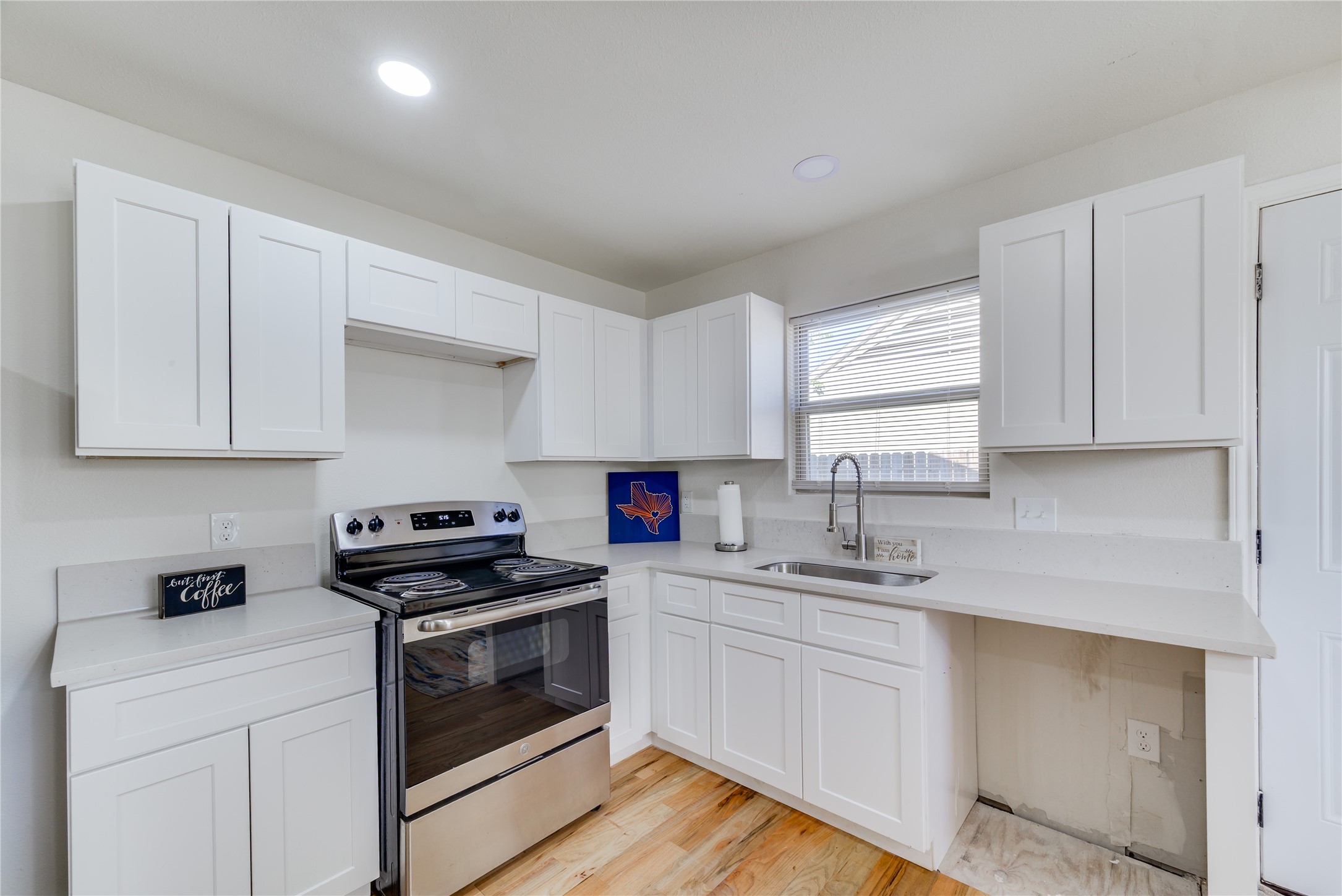 6603 Victoria Street Houston, TX 77020 - Photo 9 of 34 a kitchen with cabinets appliances a sink and a window