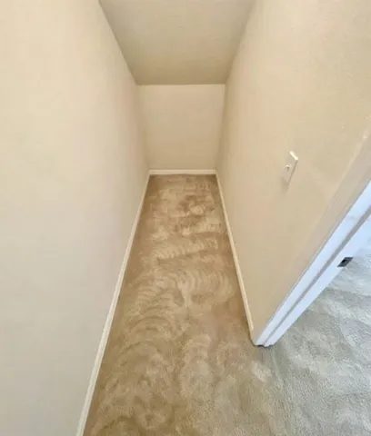 a backyard of a house with yard table and chairs
