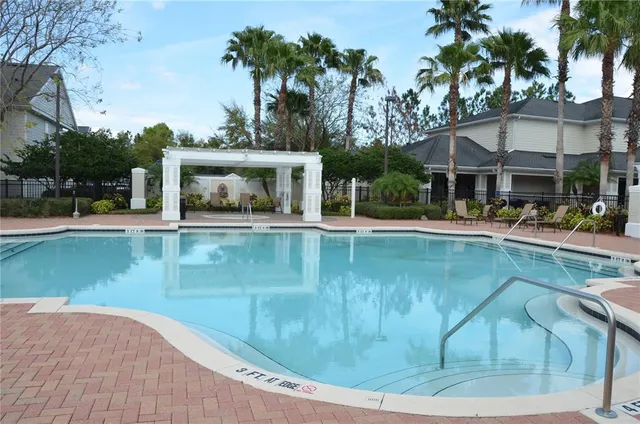 a view of a swimming pool with outdoor seating