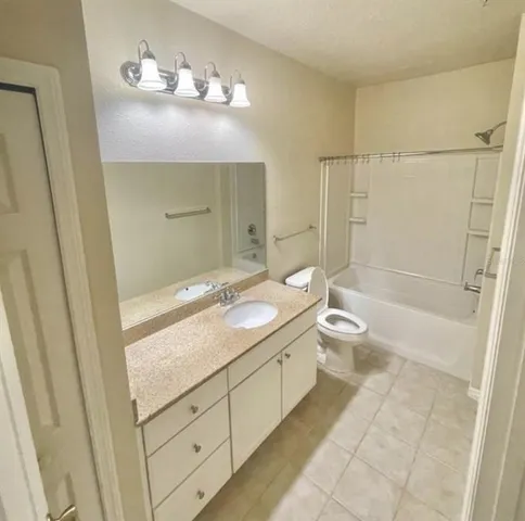 a bathroom with a double vanity sink toilet and shower