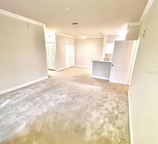 a view of a kitchen with a sink and a refrigerator