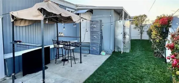 a view of a patio with table and chairs with wooden fence