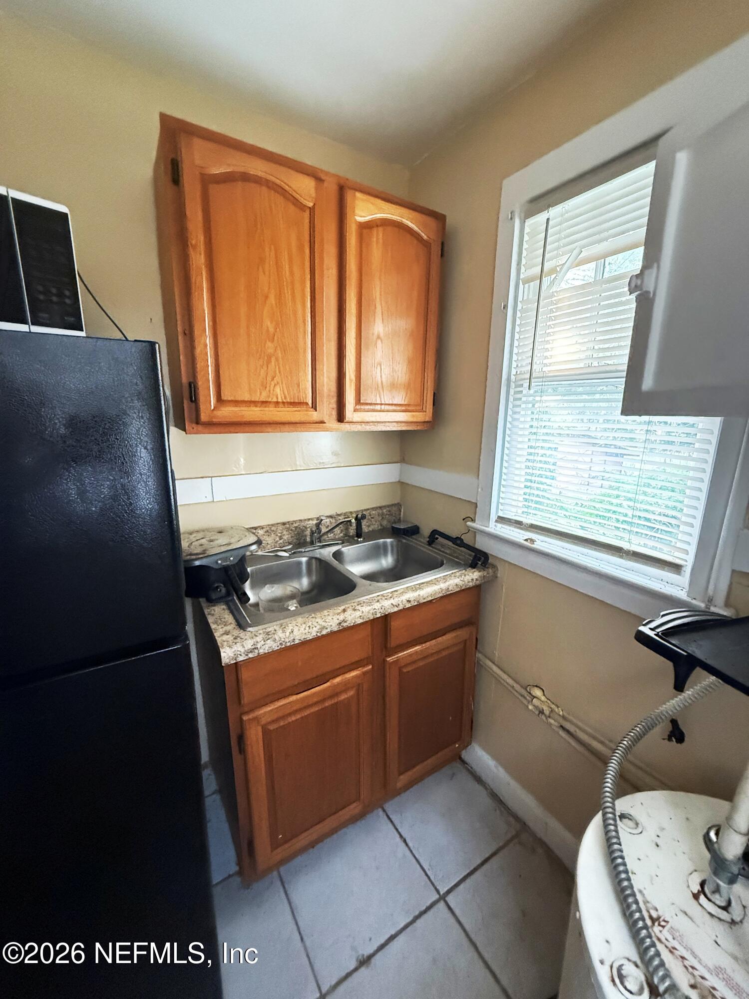 2036 Moncrief Road Jacksonville, FL 32209 - Photo 28 of 32 a kitchen with stainless steel appliances granite countertop a stove a sink and a refrigerator