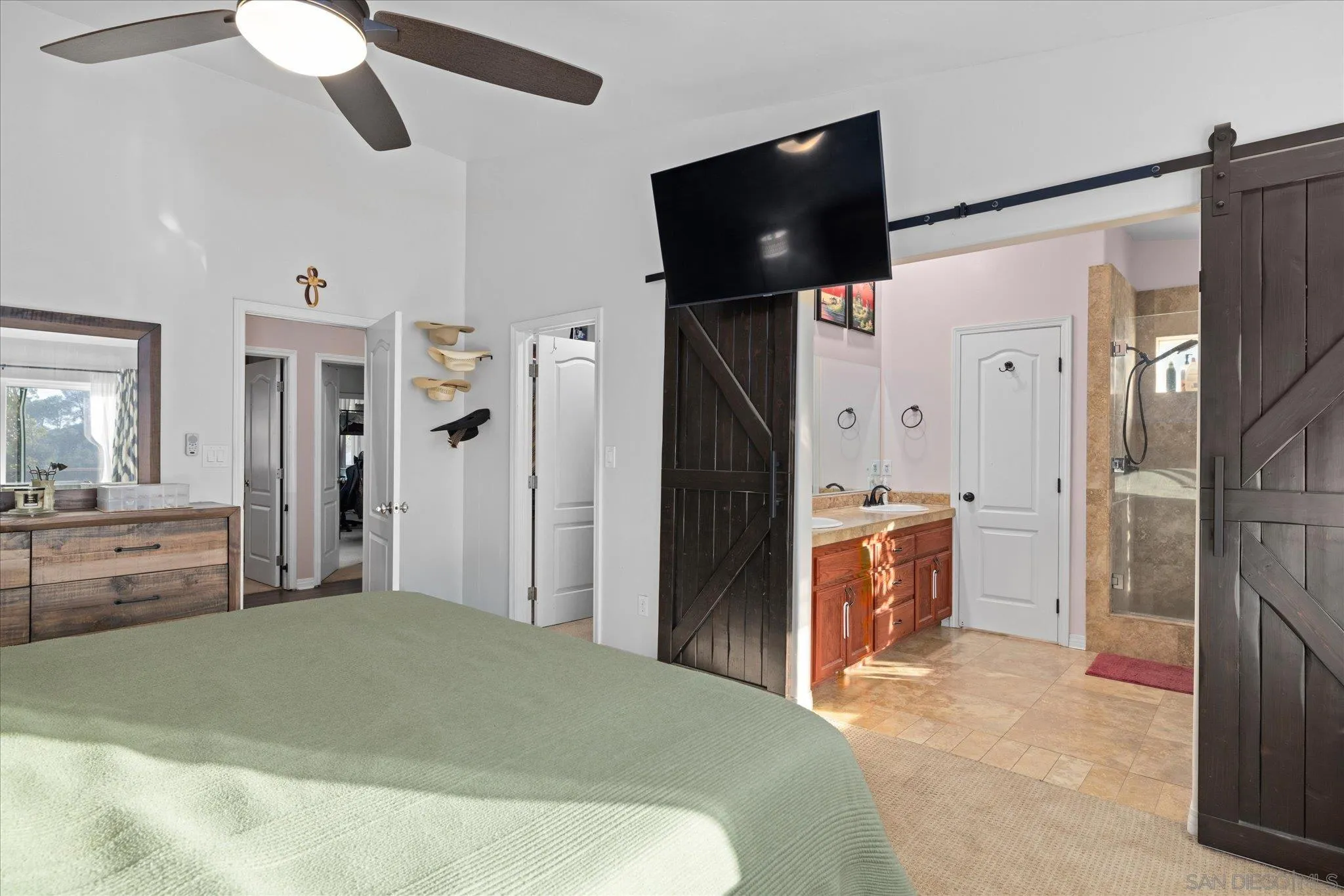 1714 Foss Road Alpine, CA 91901 - Photo 26 of 66 a spacious bedroom with a bed and a flat screen tv