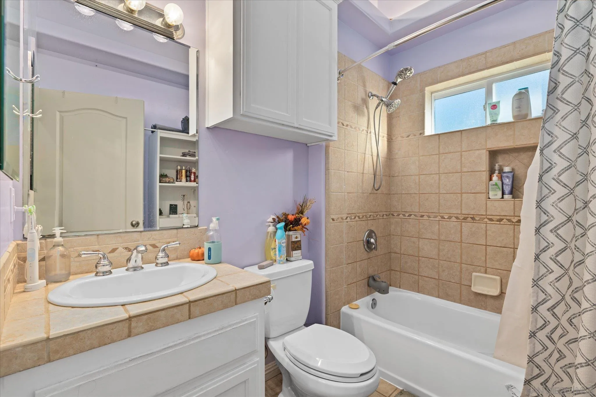 1714 Foss Road Alpine, CA 91901 - Photo 34 of 66 a bathroom with a sink a toilet a mirror a bathtub and shower