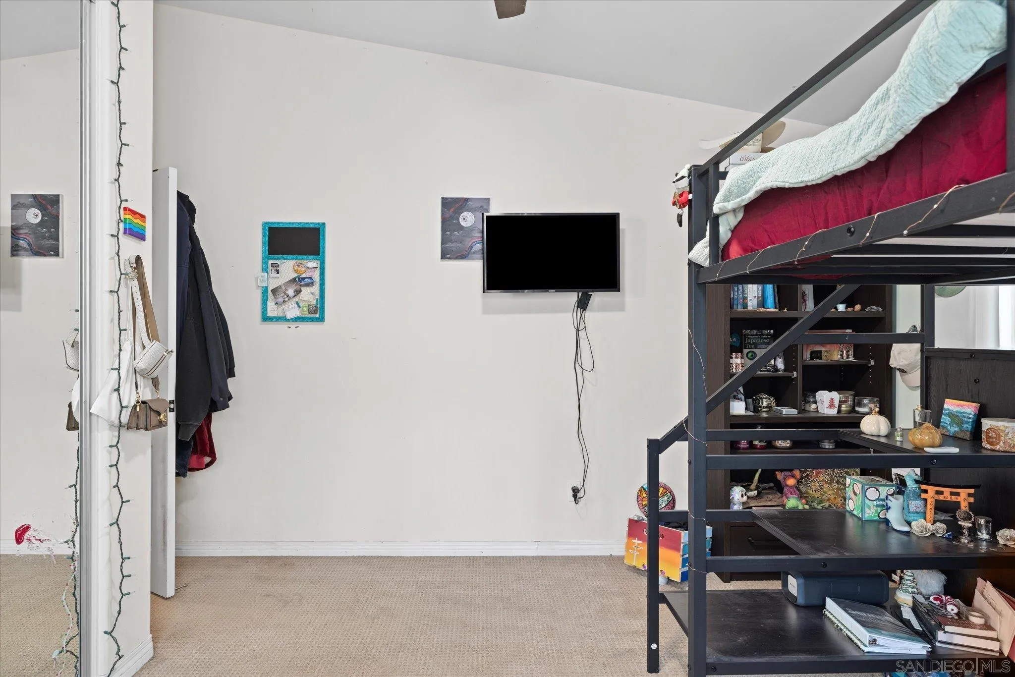 1714 Foss Road Alpine, CA 91901 - Photo 36 of 66 a living room with lots of books and a flat screen tv