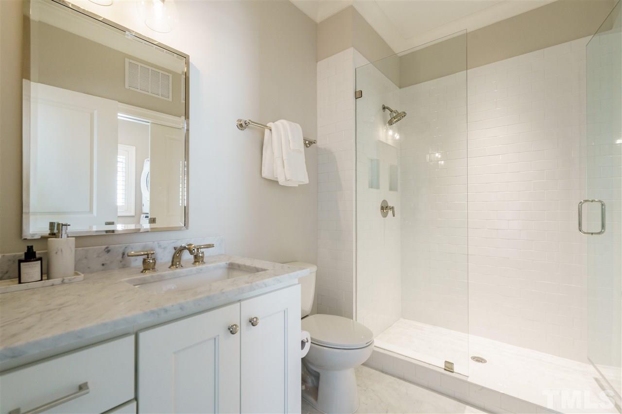 604 Daniels Street, Unit B Raleigh, NC 27605 - Photo 11 of 20 a bathroom with a granite countertop sink a toilet and shower