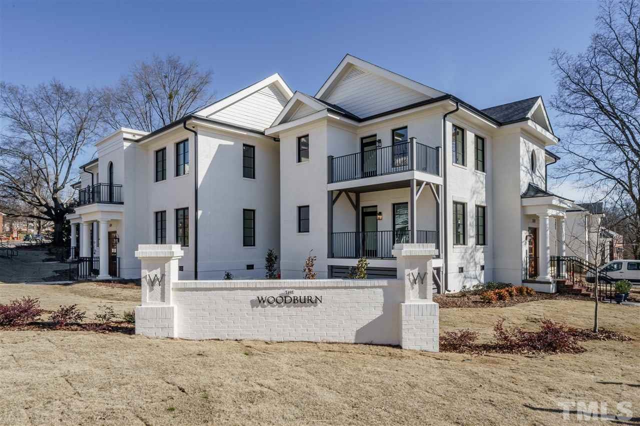 604 Daniels Street, Unit B Raleigh, NC 27605 - Photo 16 of 20 a view of a white house with a large tree in front of it