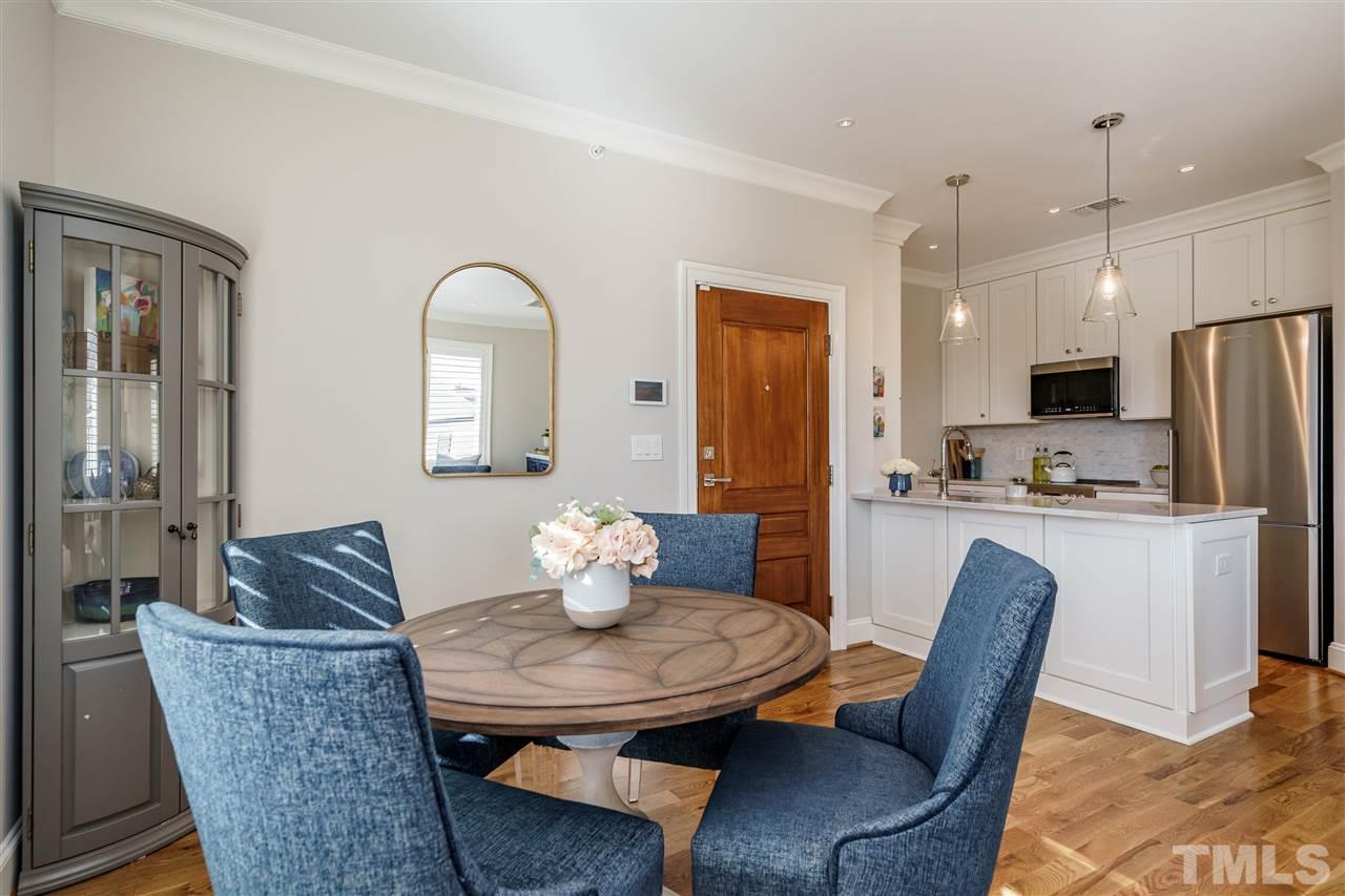 604 Daniels Street, Unit B Raleigh, NC 27605 - Photo 5 of 20 a dining room with furniture and a chandelier
