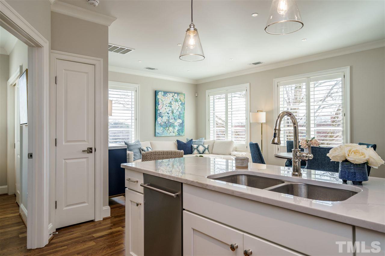 604 Daniels Street, Unit B Raleigh, NC 27605 - Photo 8 of 20 a kitchen with granite countertop a sink and a window