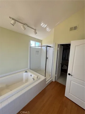 a bathroom with a bathtub and a shower
