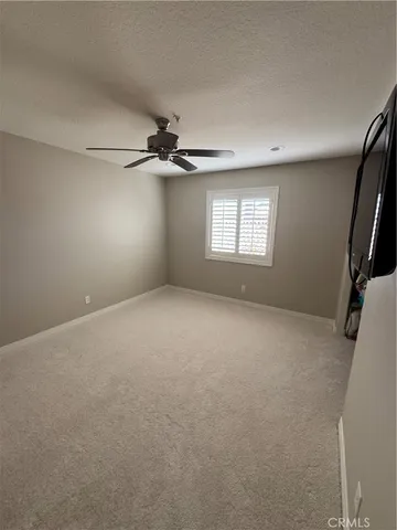 a view of a livingroom with a ceiling fan and window