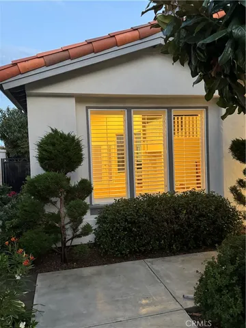 a front view of house with a garden