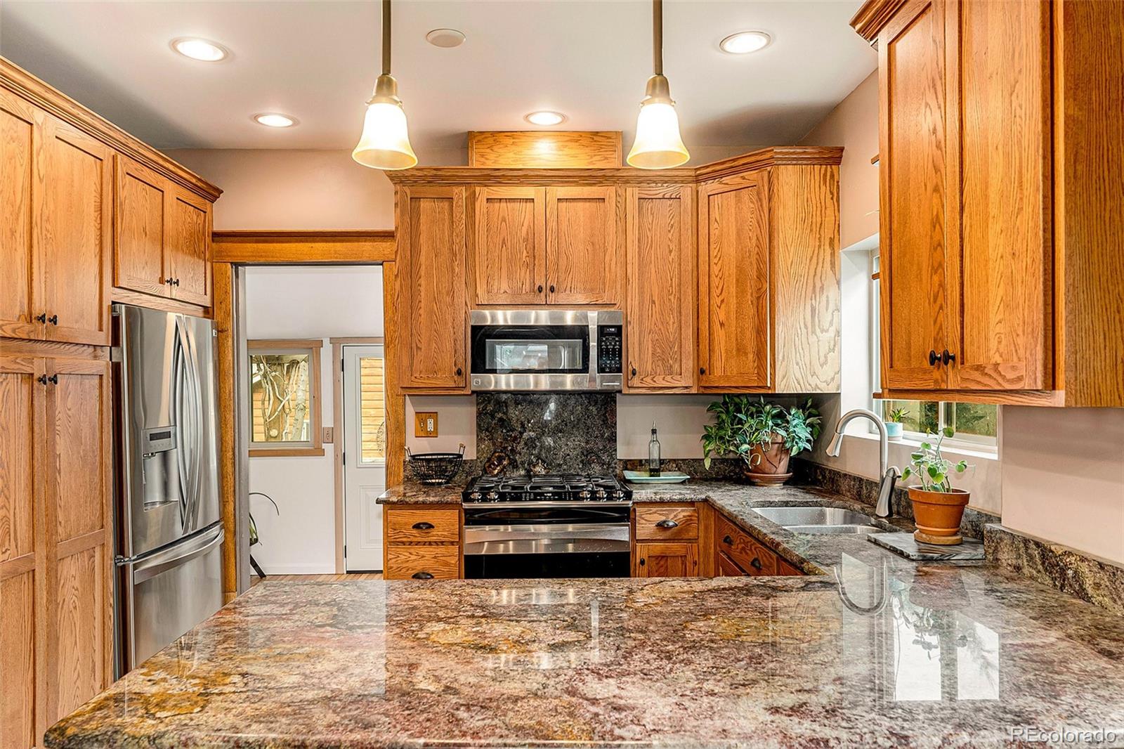 3548 Clay Street Denver, CO 80211 - Photo 11 of 30 a kitchen with stainless steel appliances granite countertop a refrigerator a stove and a sink
