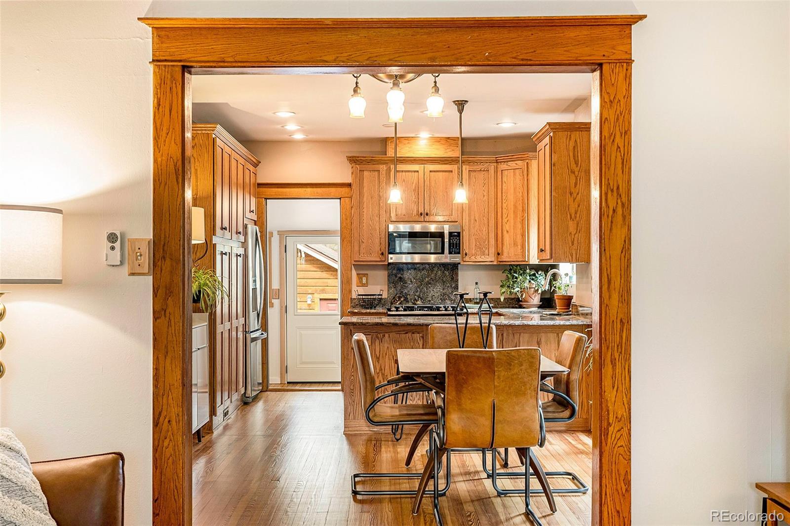 3548 Clay Street Denver, CO 80211 - Photo 12 of 30 a kitchen with stainless steel appliances granite countertop a refrigerator and wooden cabinets