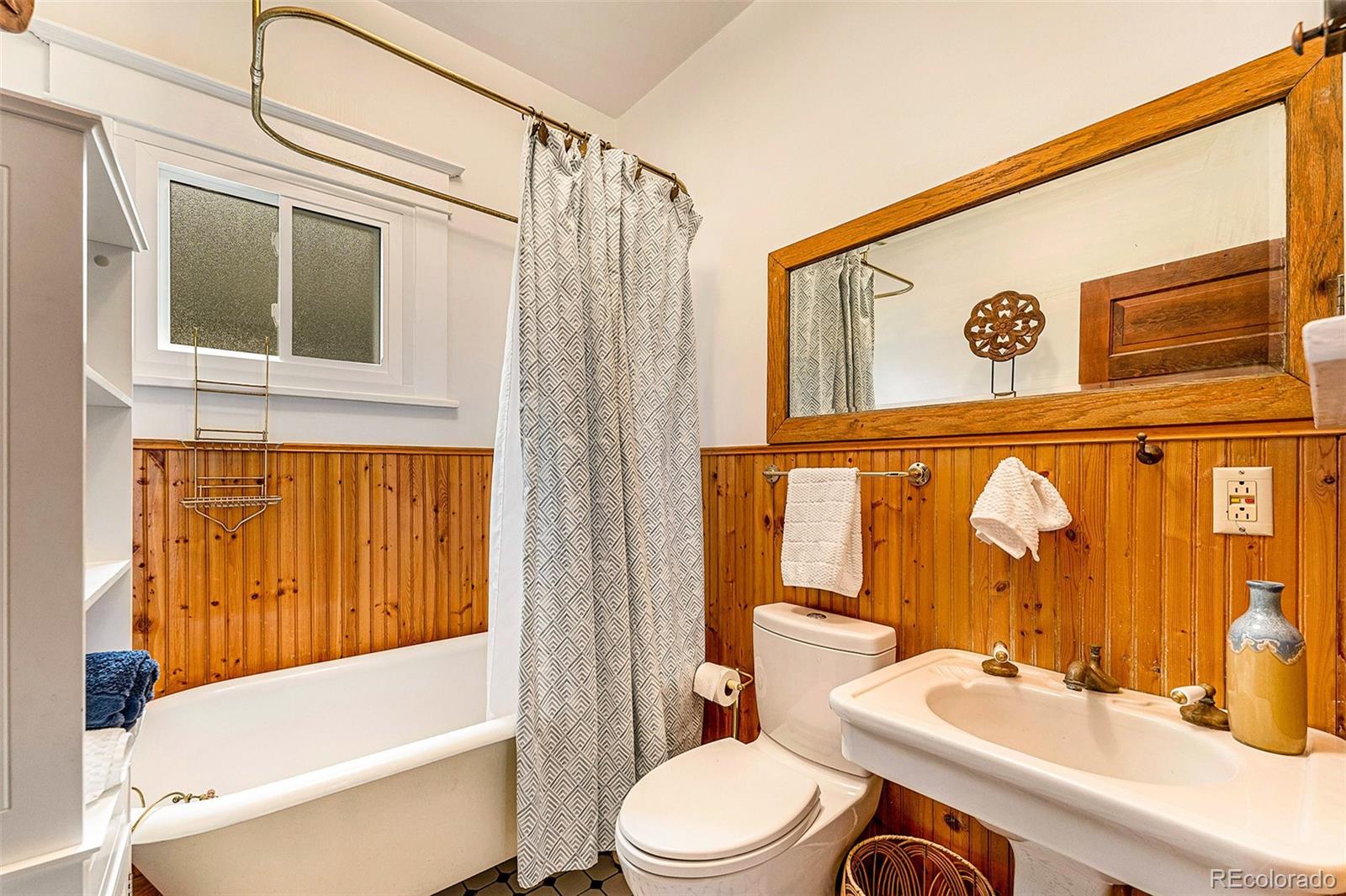 3548 Clay Street Denver, CO 80211 - Photo 15 of 30 a bathroom with a sink a toilet and shower