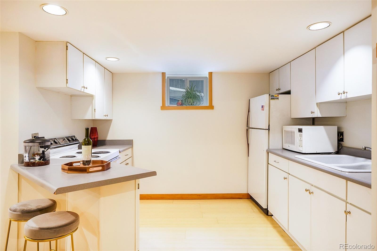3548 Clay Street Denver, CO 80211 - Photo 22 of 30 a kitchen with stainless steel appliances granite countertop a sink stove and white cabinets