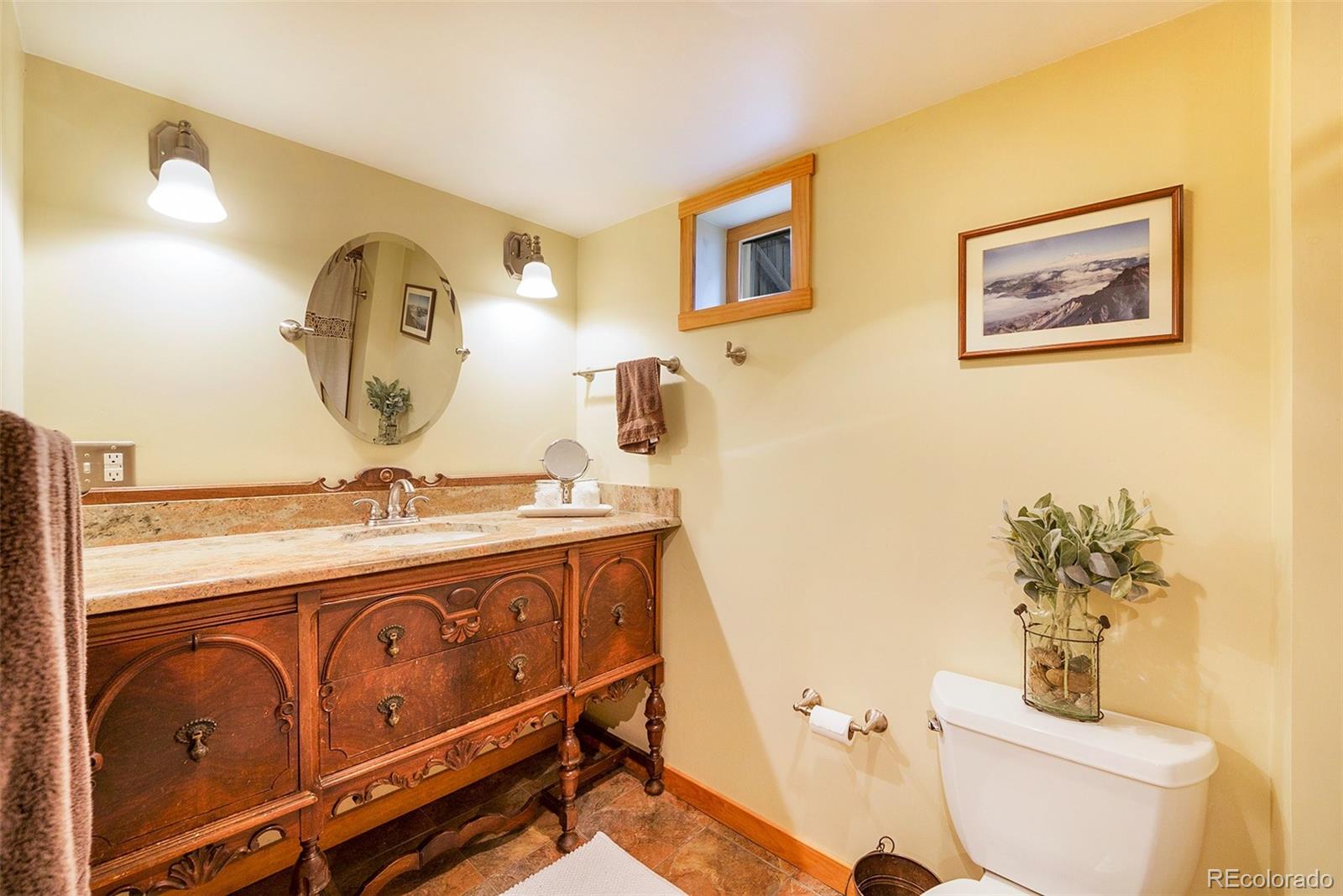 3548 Clay Street Denver, CO 80211 - Photo 24 of 30 a bathroom with a toilet a sink and mirror