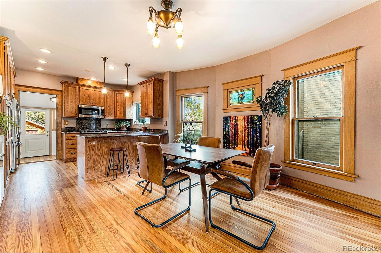 3548 Clay Street Denver, CO 80211 - Photo 6 of 30 a view of a dining room with furniture a chandelier and wooden floor