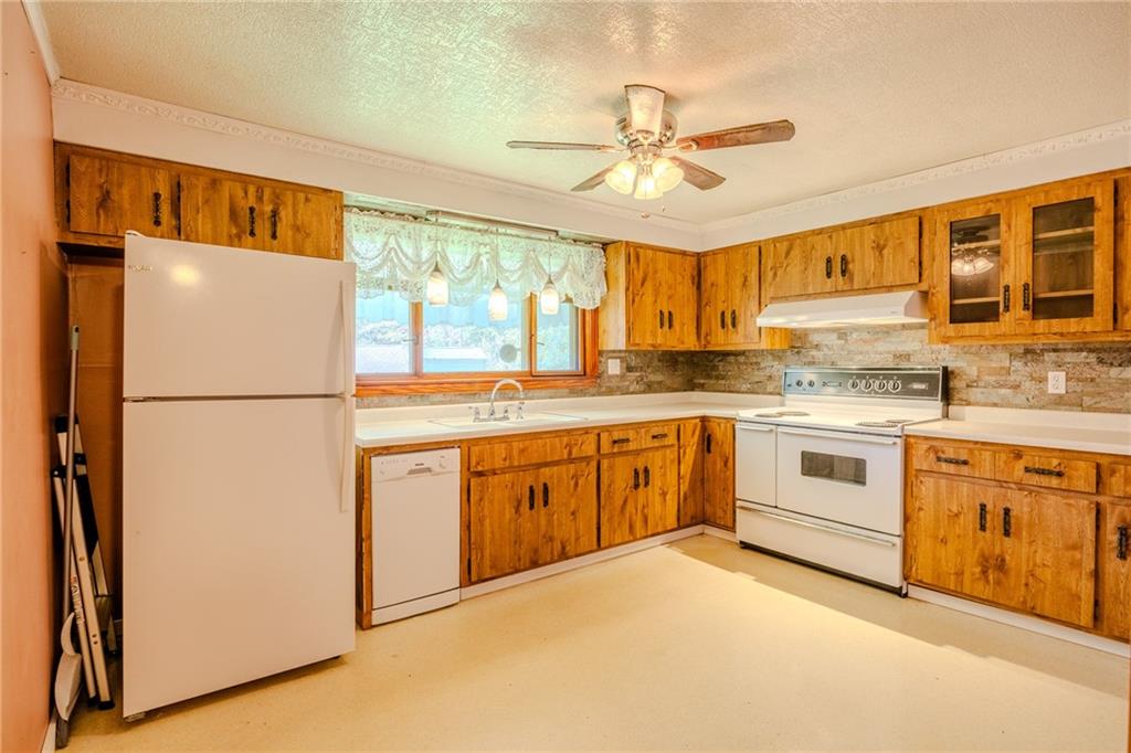 181 Firden Lane Elizabeth, PA 15037 - Photo 4 of 25 a kitchen with stainless steel appliances granite countertop a refrigerator a stove a sink and white cabinets