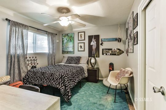 429 West Perdew Avenue Ridgecrest, CA 93555 - Photo 25 of 50 a bedroom with a bed and a chandelier