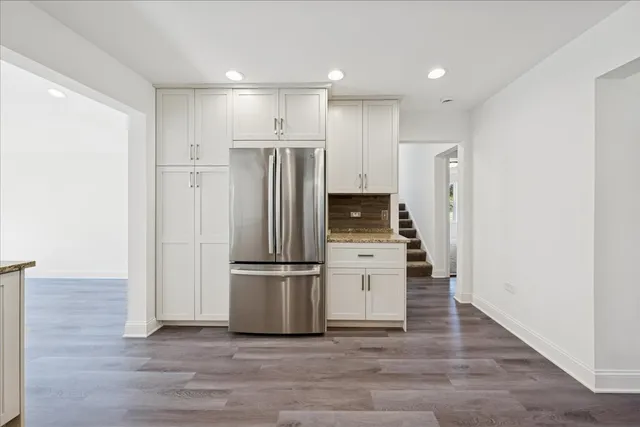 a kitchen with kitchen island wooden cabinets and stainless steel appliances