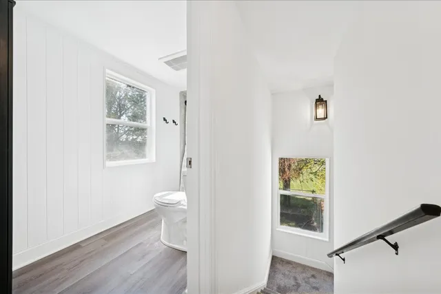 a bathroom with a toilet sink and a mirror