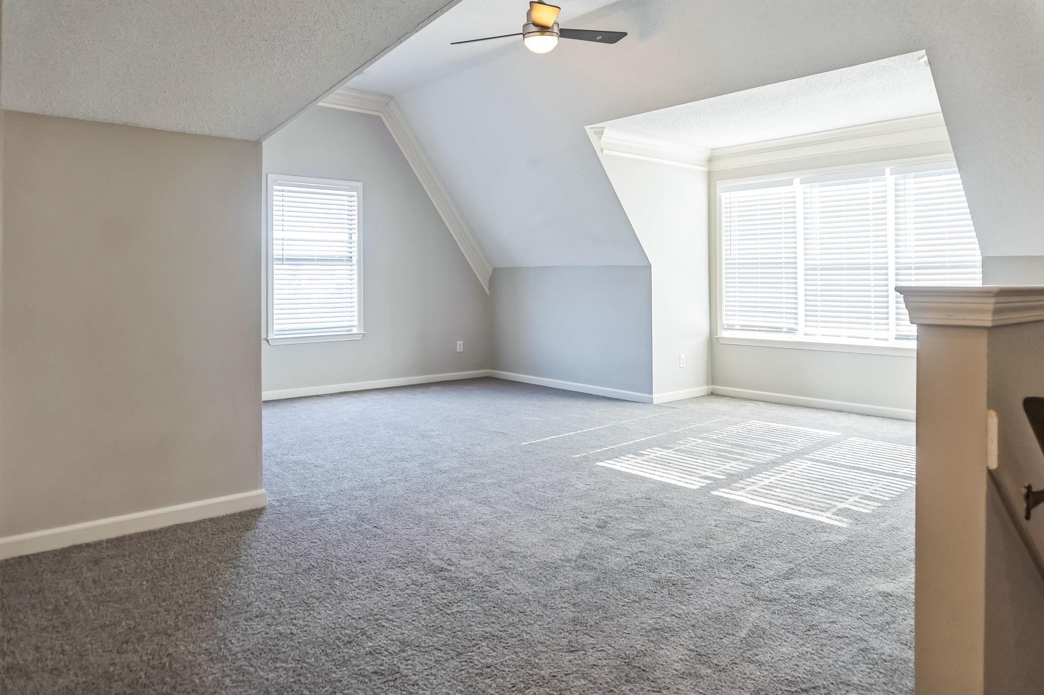5225 Rockyford Road Bartlett, TN 38002 - Photo 15 of 18 Bonus room featuring vaulted ceiling, ceiling fan, plenty of natural light, and light colored carpet