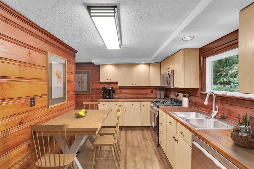 155 Harrold Street Jeannette, PA 15644 - Photo 17 of 37 a kitchen with a sink a counter top space and living room area