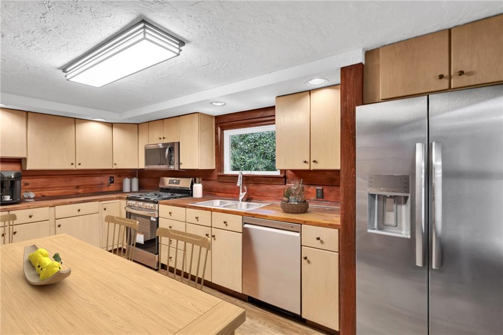 155 Harrold Street Jeannette, PA 15644 - Photo 19 of 37 a kitchen with a sink stainless steel appliances cabinets and a counter top space
