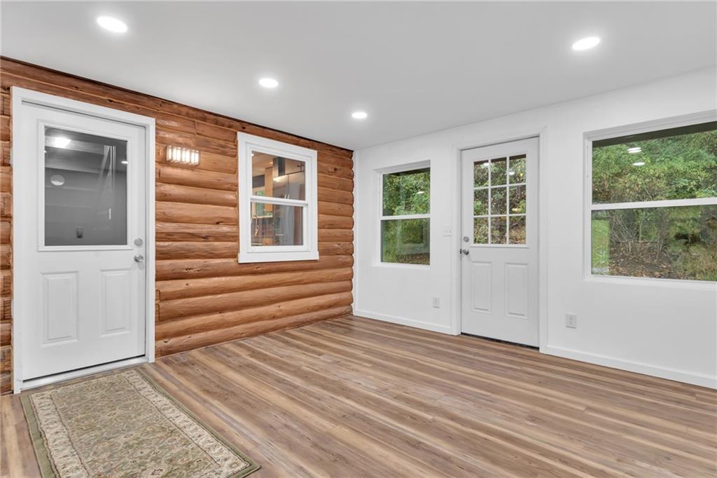 155 Harrold Street Jeannette, PA 15644 - Photo 5 of 37 an empty room with wooden floor and windows