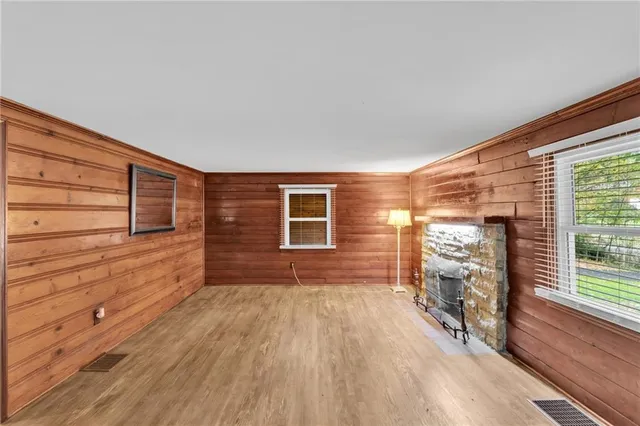 a view of house with deck and wooden floor