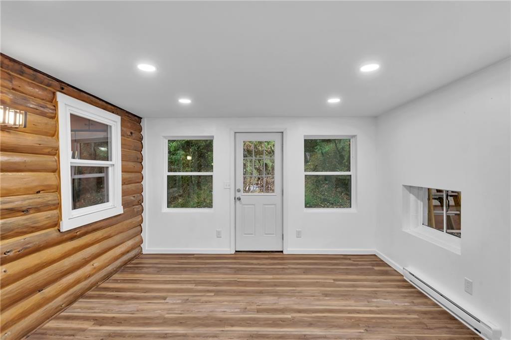 155 Harrold Street Jeannette, PA 15644 - Photo 7 of 37 a view of an empty room with wooden floor and windows