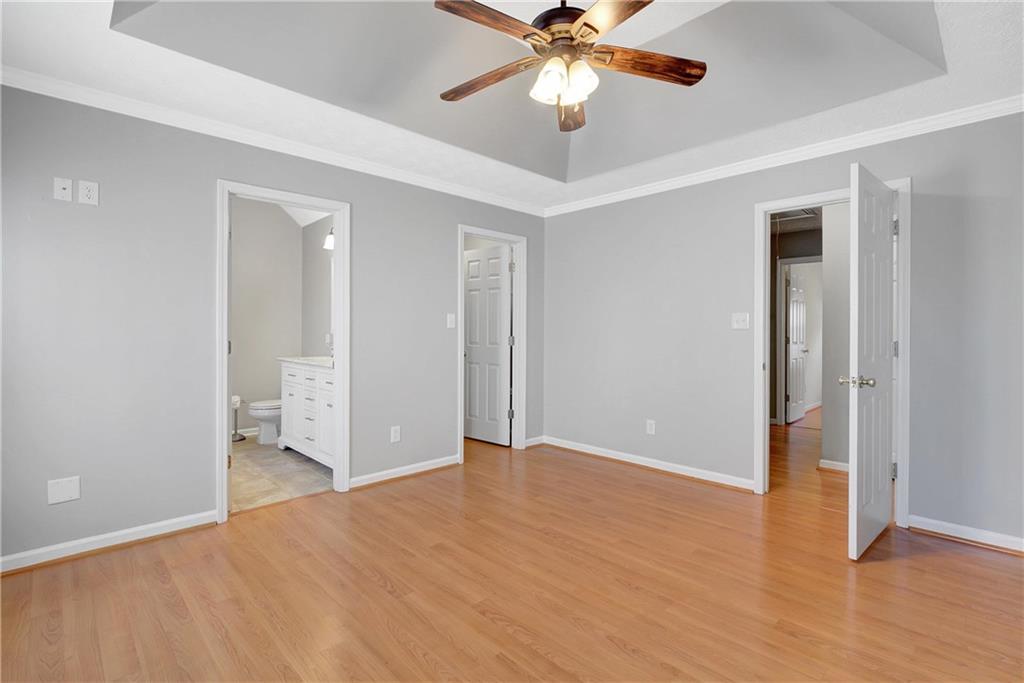 7 Buck Trail Newnan, GA 30265 - Photo 18 of 37 an empty room with wooden floor and fan