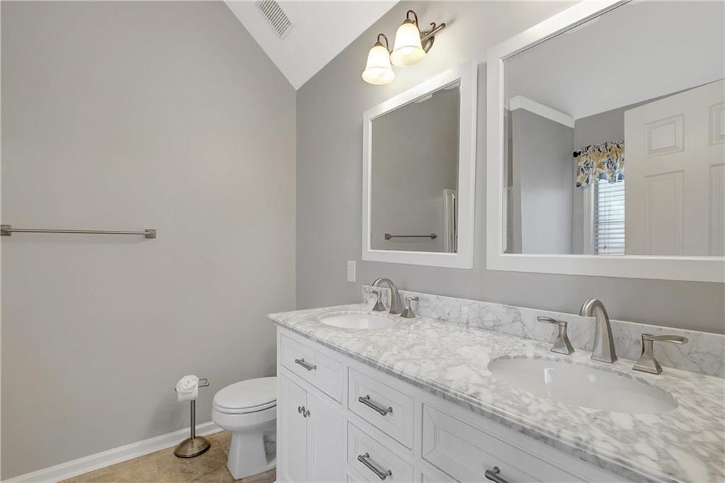 7 Buck Trail Newnan, GA 30265 - Photo 21 of 37 a bathroom with a granite countertop sink a toilet and a mirror