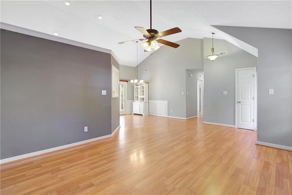 7 Buck Trail Newnan, GA 30265 - Photo 5 of 37 a view of a livingroom with a ceiling fan and wooden floor
