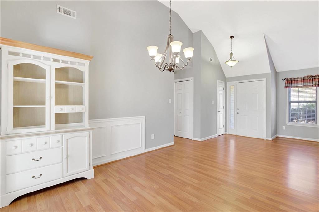 7 Buck Trail Newnan, GA 30265 - Photo 9 of 37 a view of an empty room with a window and wooden floor